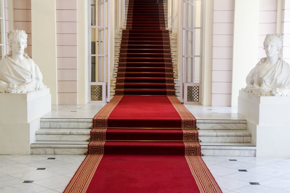 Majestic entrance with red carpet and statues at Albertina Museum in Vienna
