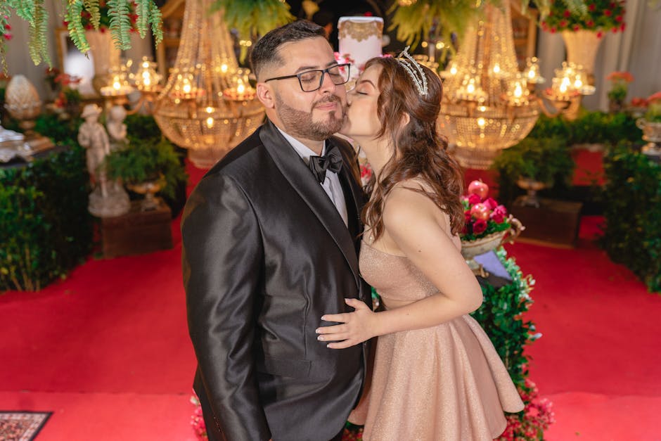 A couple dressed elegantly enjoys a luxurious indoor celebration, surrounded by ornate decor and vibrant lighting